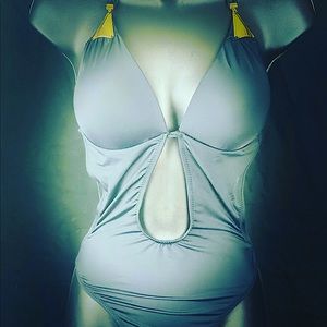 Black gold strapped shows partial stomach center piece bathing suit